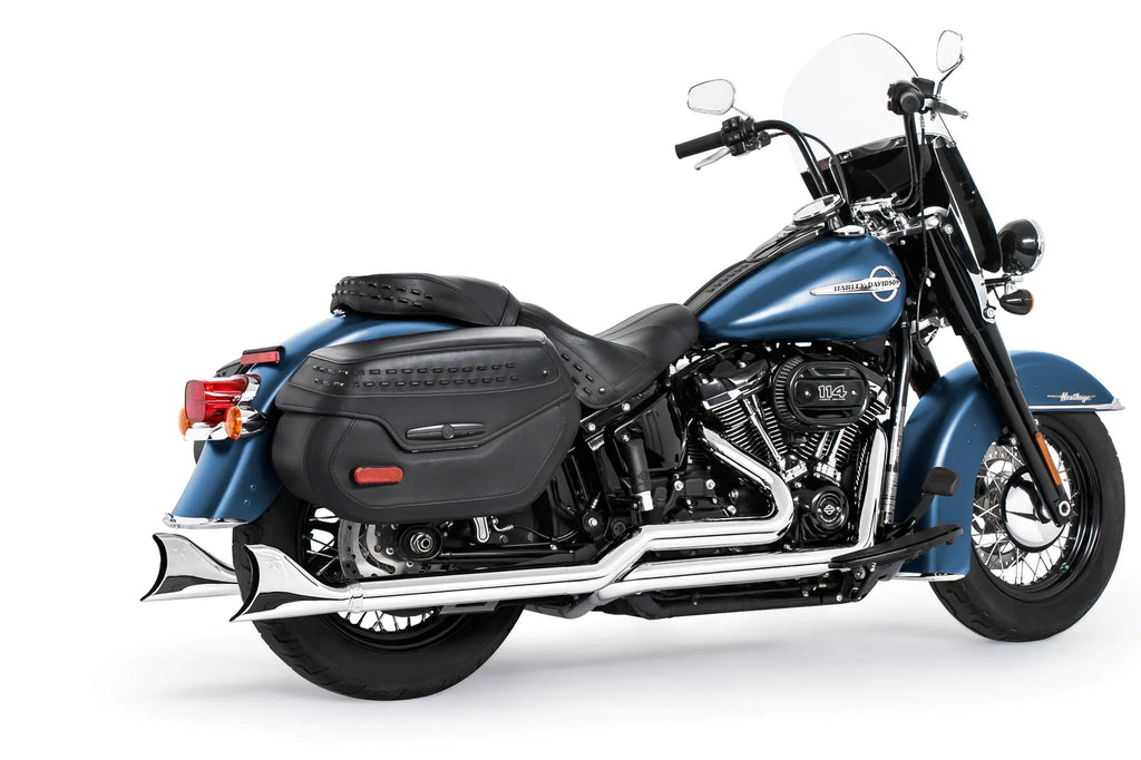 A blue motorcycle with a 1986-2024 HARLEY SOFTAIL - 2.5" CLASSIC SHARKTAIL TRUE-DUALS COMPLETE EXHAUST SYSTEM by Freedom Performance and black leather saddlebags.