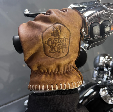 A Cuztom Kraft Bad Ass Leather Riding Glove - Tan with a logo on it, made from genuine leather.