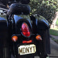 A black Indian Motorcycle Turn Signal Lenses motorcycle parked in a driveway. (Brand Name: Cuztom Kraft)