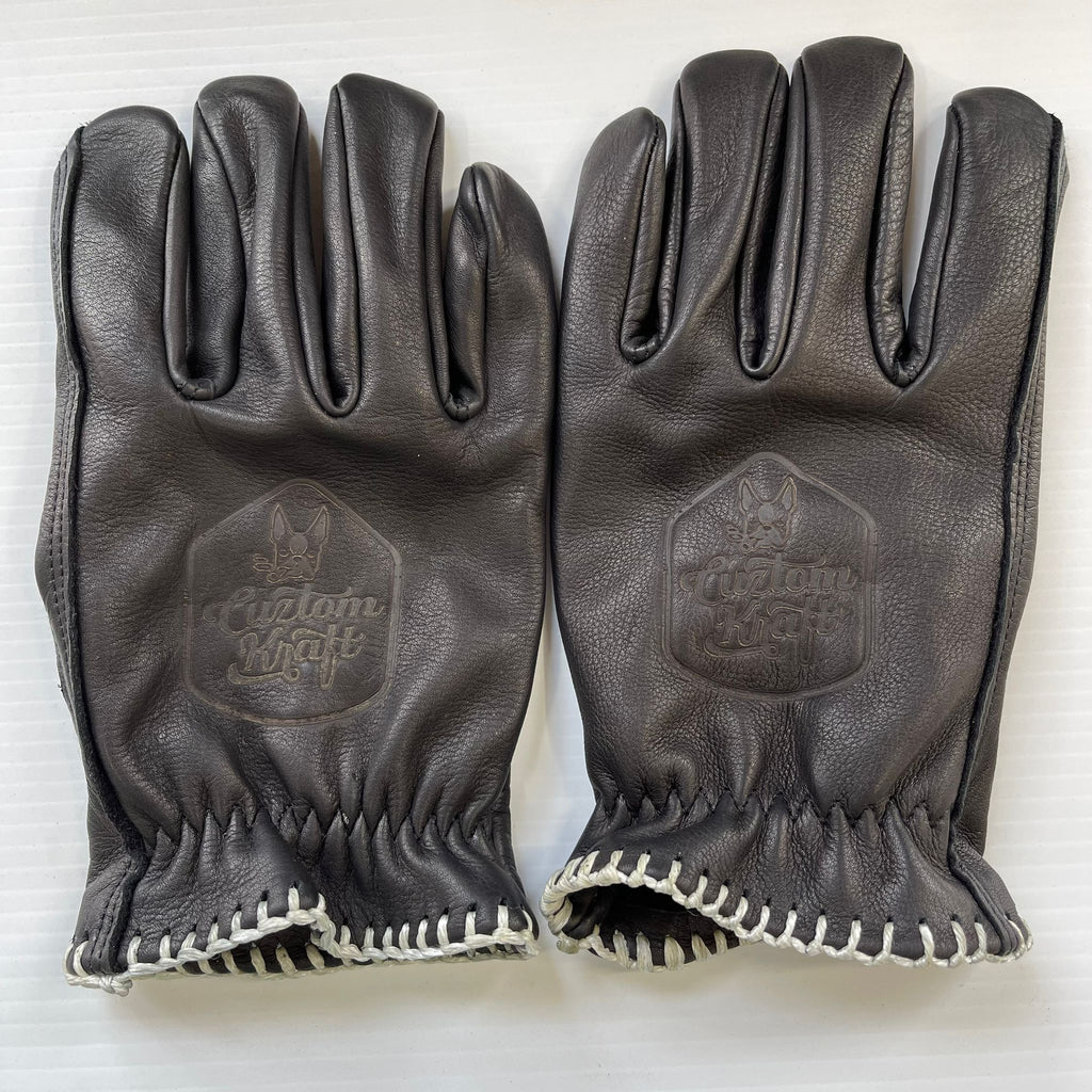 A pair of Bad Ass Leather Riding Gloves - Black, crafted with genuine black leather and adorned with white stitching, by Cuztom Kraft.