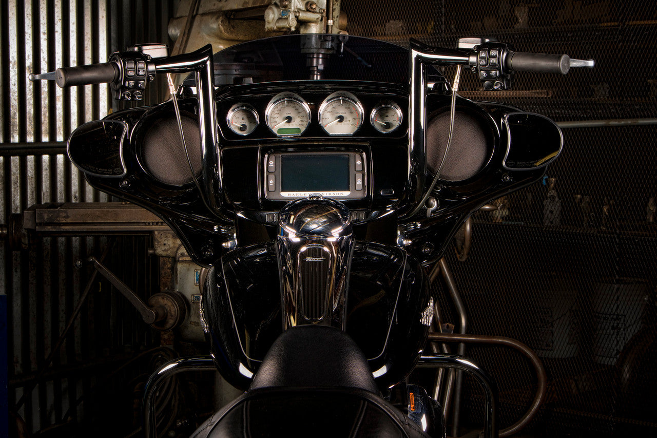 A Factory 47 Assault Handlebar 14" Black motorcycle parked in a garage.