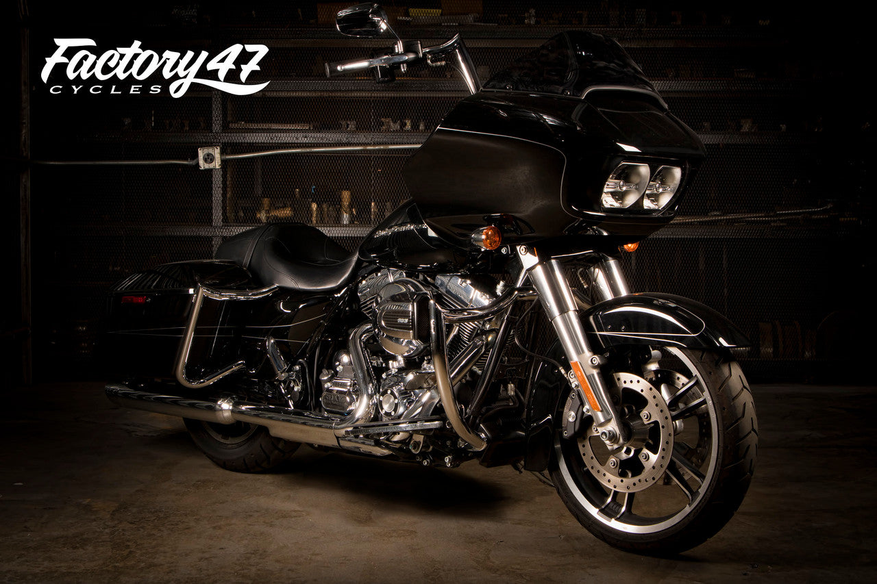 A Factory 47 Signature Handlebar Chrome 14" motorcycle is parked in a dark garage.