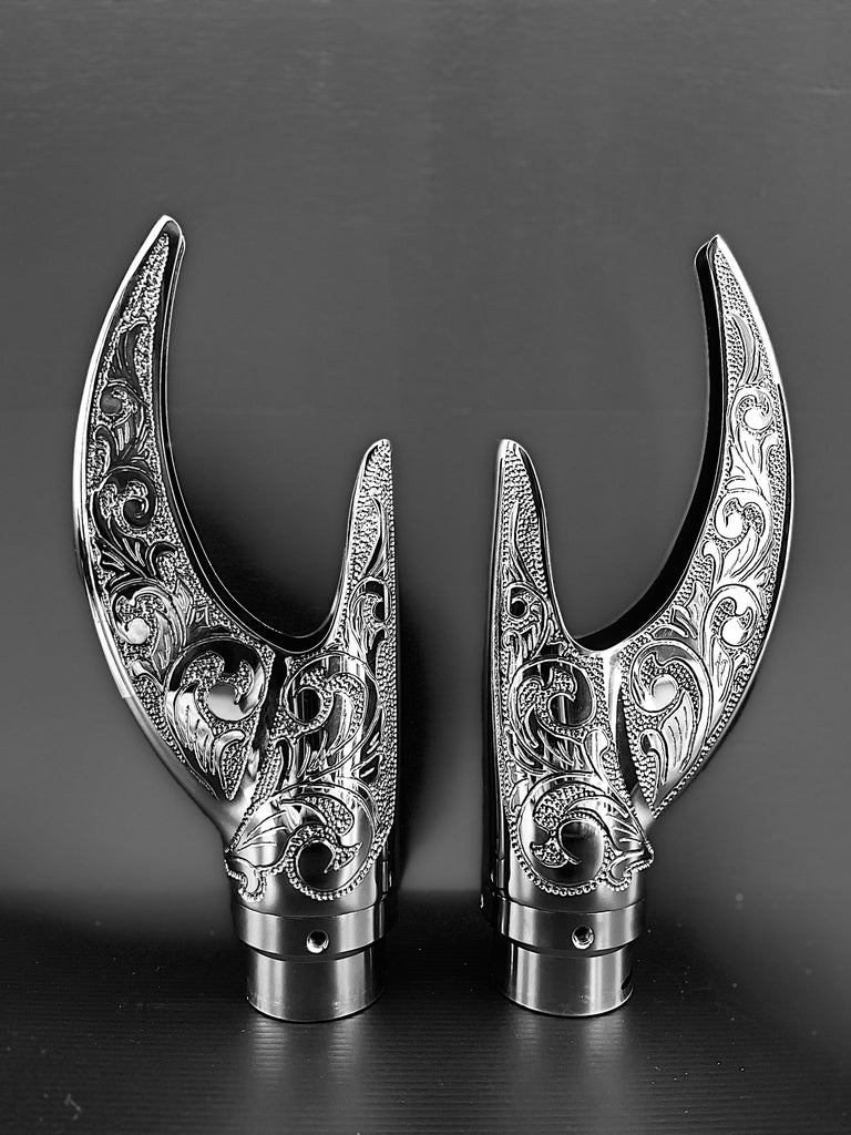 A pair of Cuztom Kraft Reaper Exhaust Tips on a black surface.